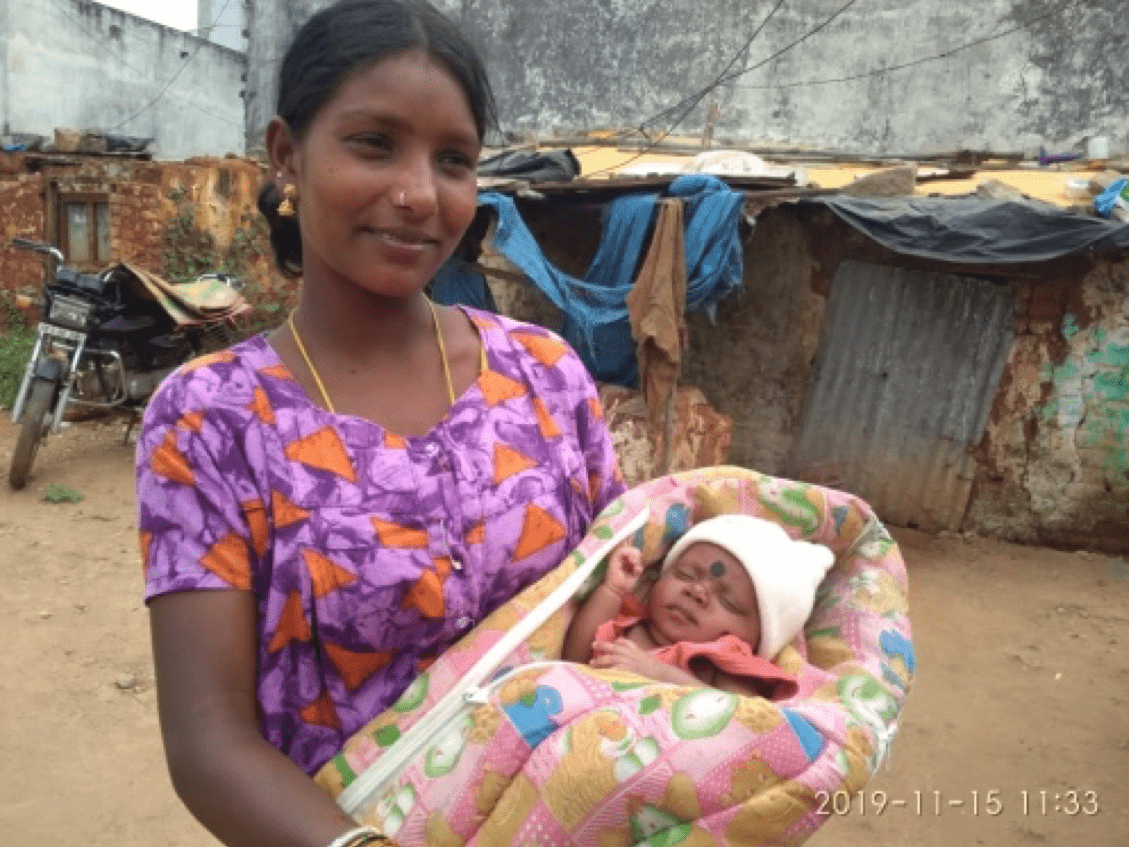 a women holds a young baby